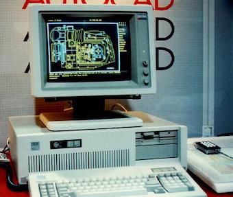 old photo of IBM PC/AT running AutoCAD in front of an AutoCAD poster