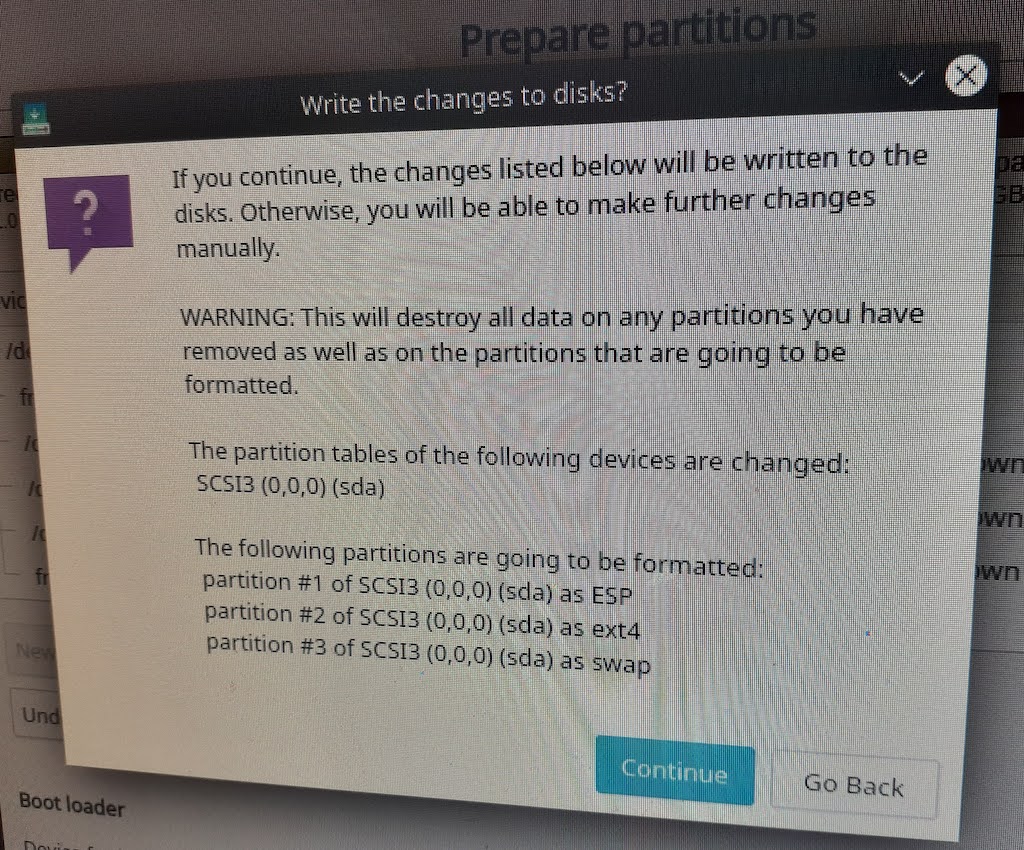 screenshot of window asking "write changes to disk" Warning, this will destroy all data on any partitions you have removed as well as on the partitions that are going to be formatted then describes the new partition table.